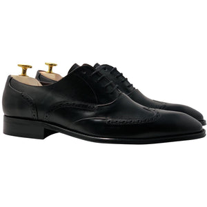 black leather shoe with brogue and wingtip design