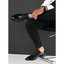 black leather shoe with brogue and wingtip design in elegant dress outfit