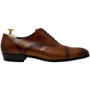 brown shoes with brogue design caramel or cognac side view