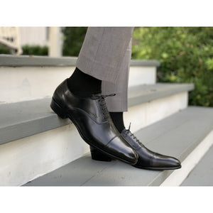 Mens handmade leather shoe in black with gray pants 