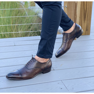 Mens dark brown leather shoes from Spain with navy blue pants
